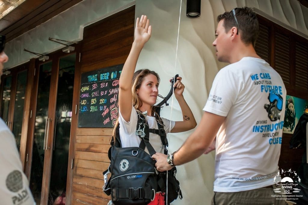 PADI IDC instructor candidate practicing a controlled emergency swimming ascent during practical training on Koh Tao.