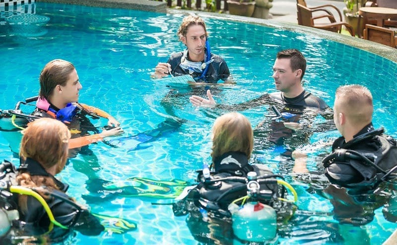 PADI IDC instructor candidates practising scuba teaching skills in the swimming pool at Sairee Cottage Diving, Koh Tao